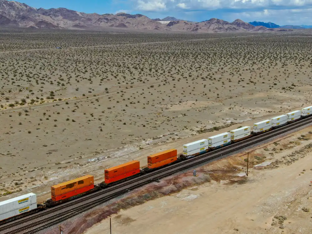 Freight locomotive pulling a long train across the Arizona desert